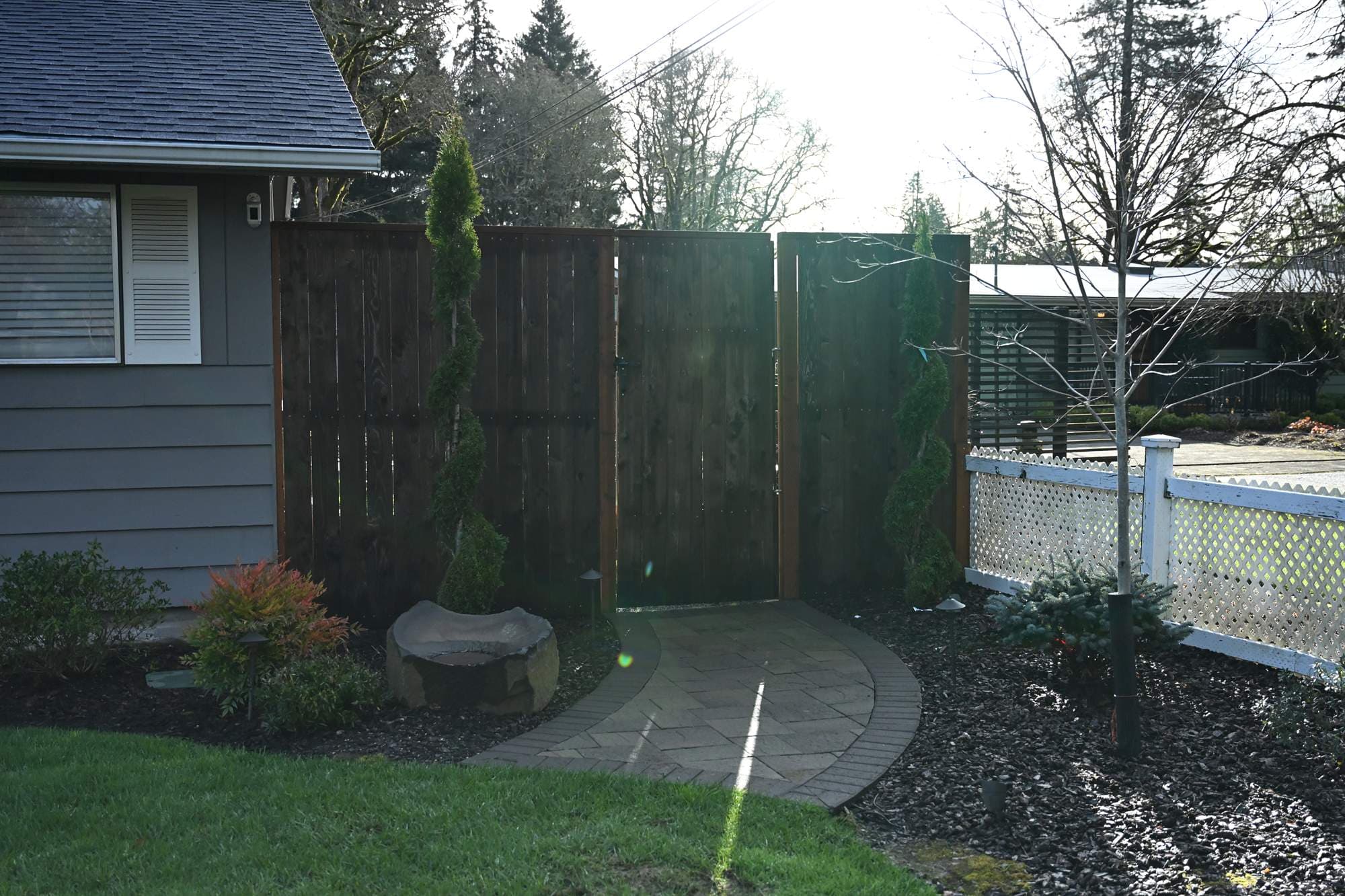 Manicured backyard lawn with crisp bed transitions along a cedar fence line