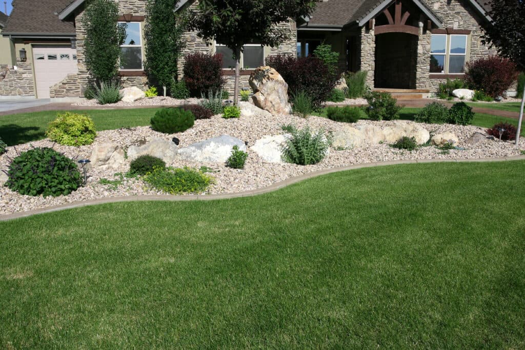 Beautiful front yard with stone accents, plants, and custom landscaping Beautiful front yard with stone accents, plants, and custom landscaping
