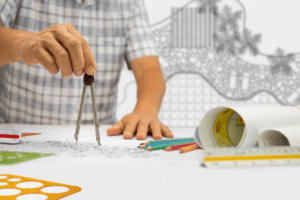 Close-up of a designer drafting a detailed garden design using technical instruments Close-up of a designer drafting a detailed garden design using technical instruments