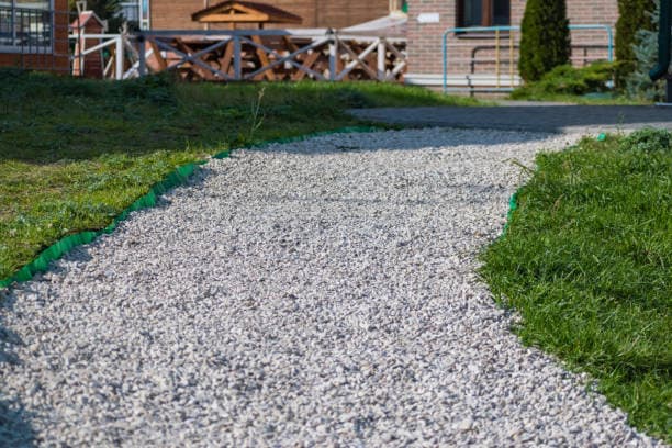 Newly installed gravel pathway leading to a cozy outdoor seating area Newly installed gravel pathway leading to a cozy outdoor seating area