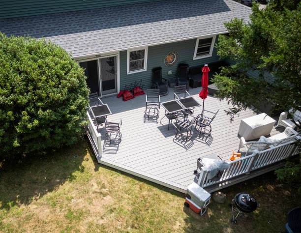 Completed deck patio with furniture, highlighting quality patio work Completed deck patio with furniture, highlighting quality patio work