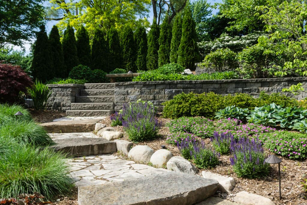Beautiful hardscape garden with stone steps, walls, and lush plants Beautiful hardscape garden with stone steps, walls, and lush plants