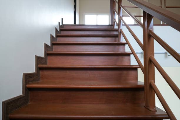 Finished wooden staircase with railings installed in a modern home Finished wooden staircase with railings installed in a modern home