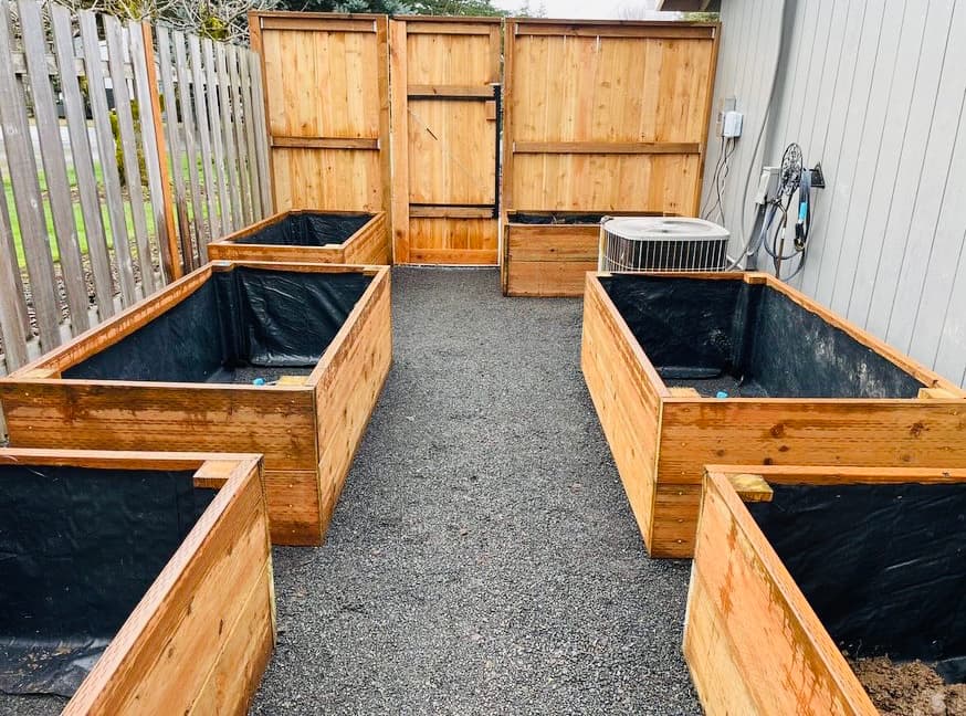 Cedar privacy gate hung plumb between matching fence panels with heavy-duty hinges and a commercial-grade latch