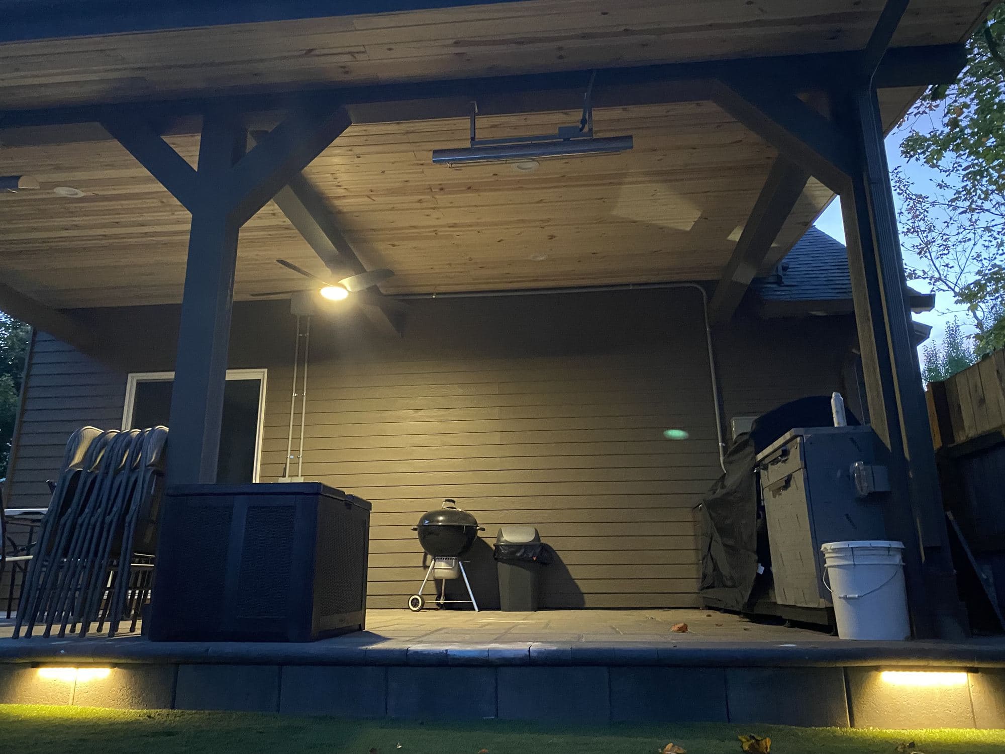 Covered patio grill station with built-in counter space beside the outdoor living area