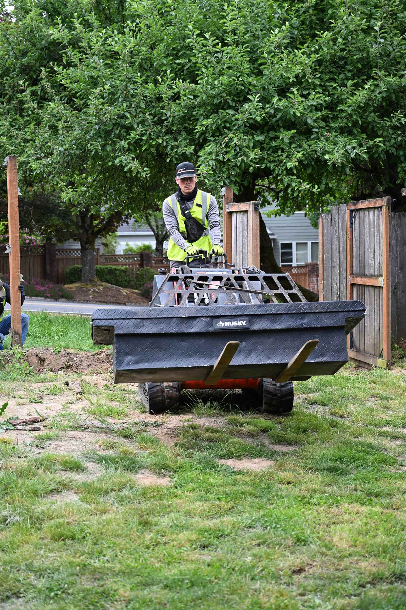 OCL crew member working a planting bed during a mulch refresh visit