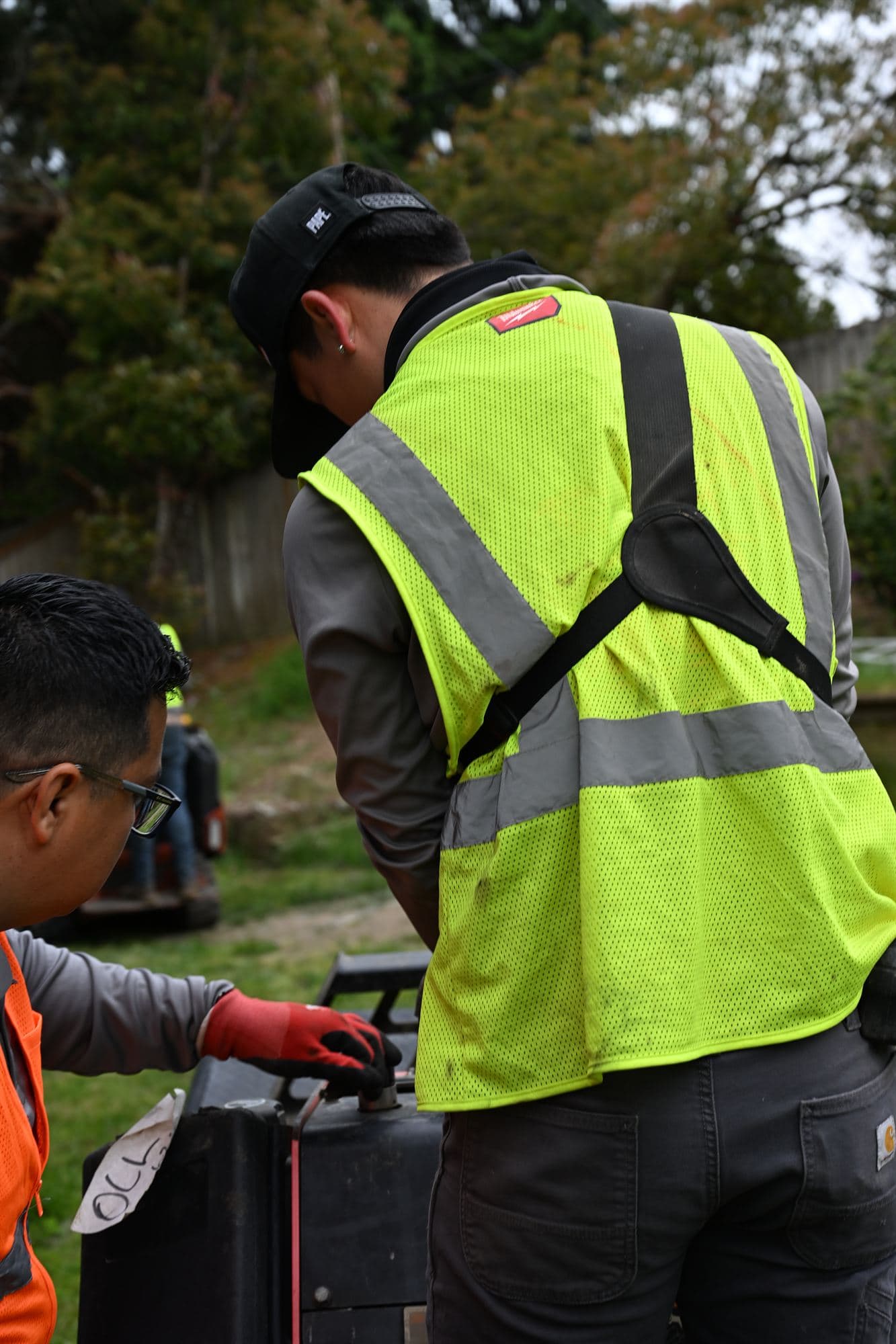 OCL crew member performing fall winterization on a residential irrigation system