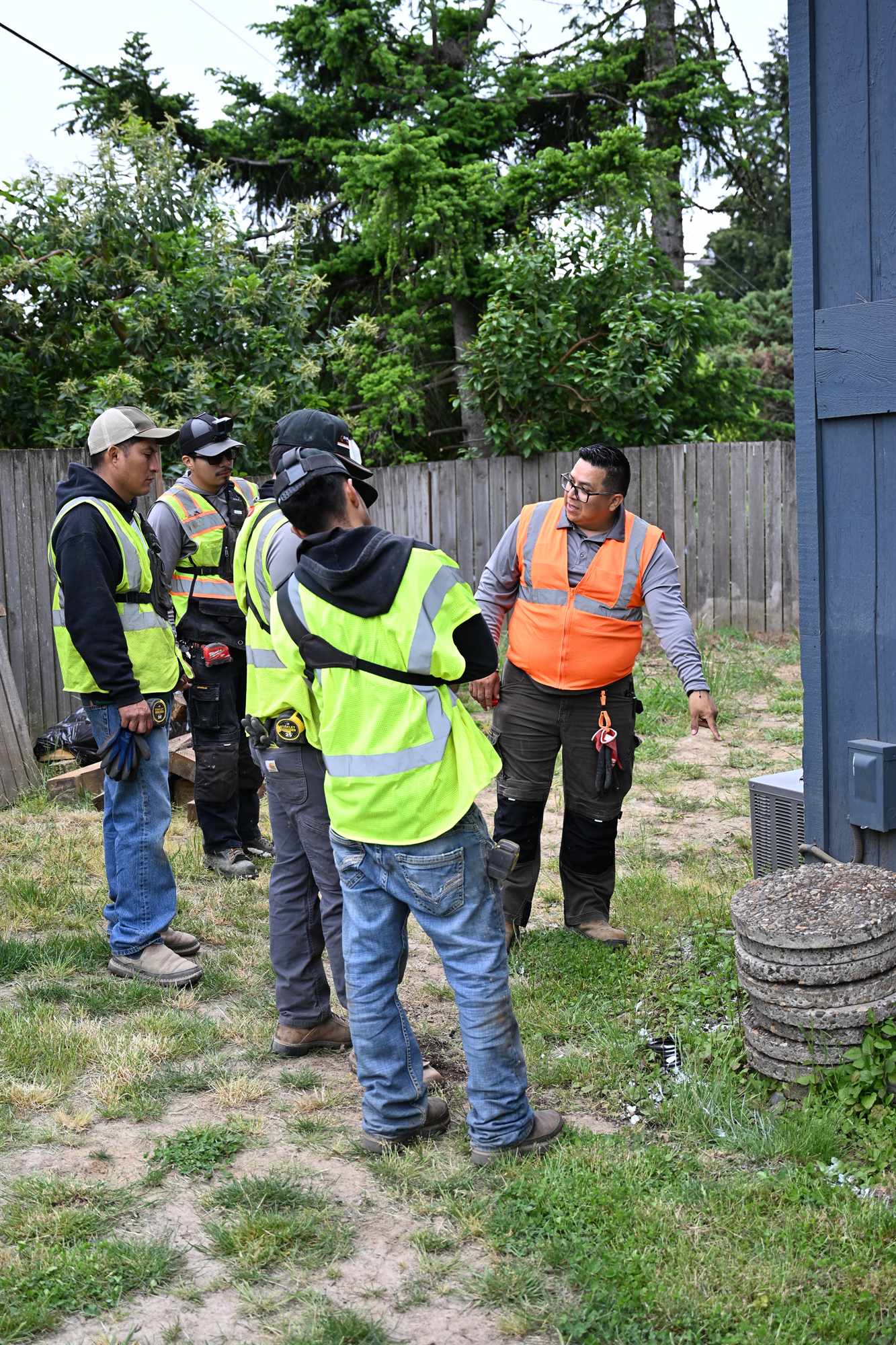 The Olguin C Landscaping crew reviewing a plan together on a job site