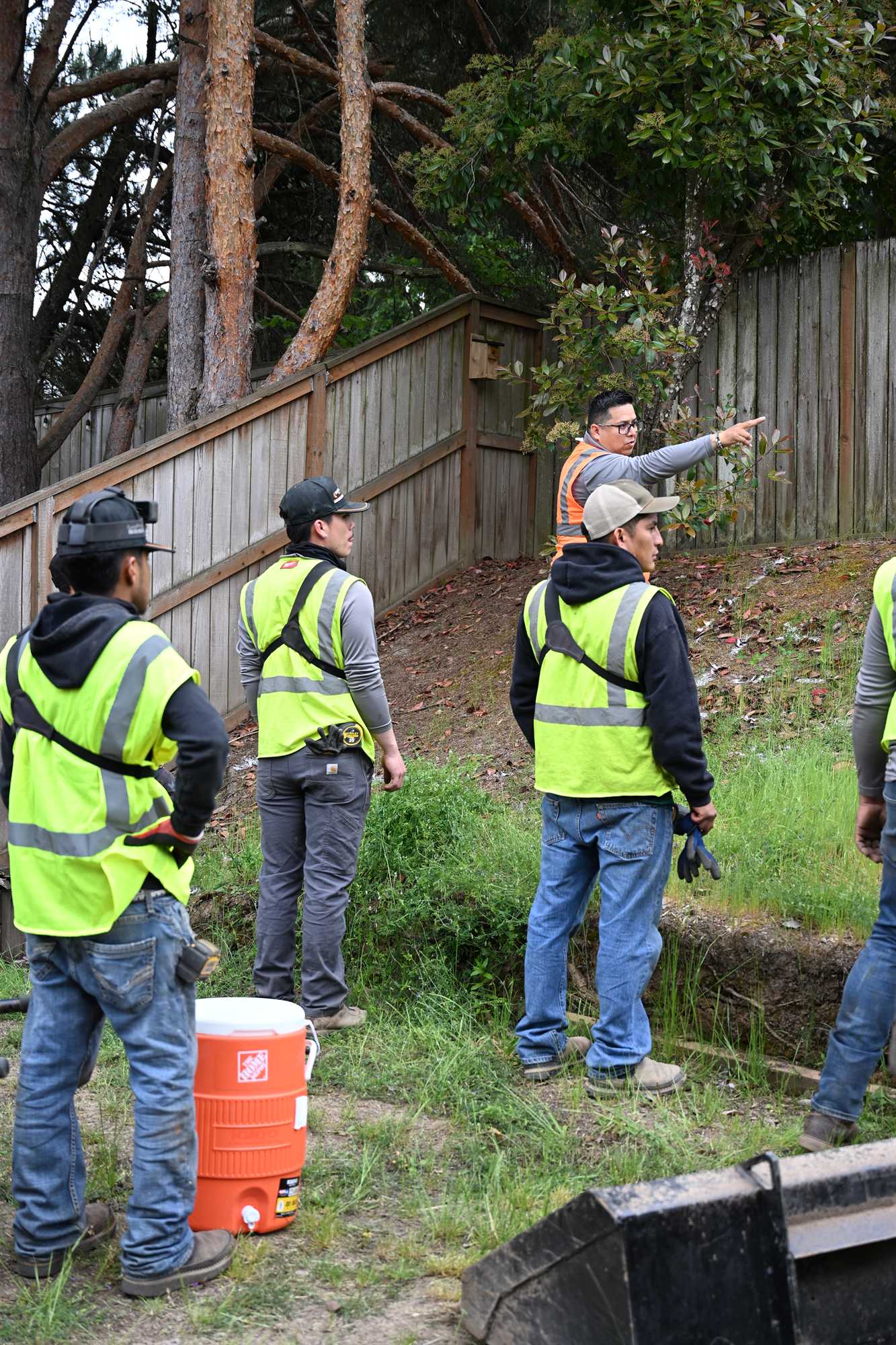 OCL crew working a commercial site with traffic cones staged along the frontage