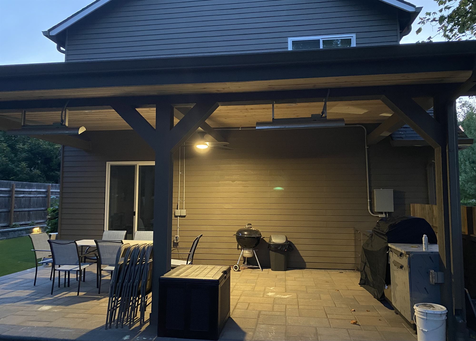 Covered patio outdoor living room with evening dining lights
