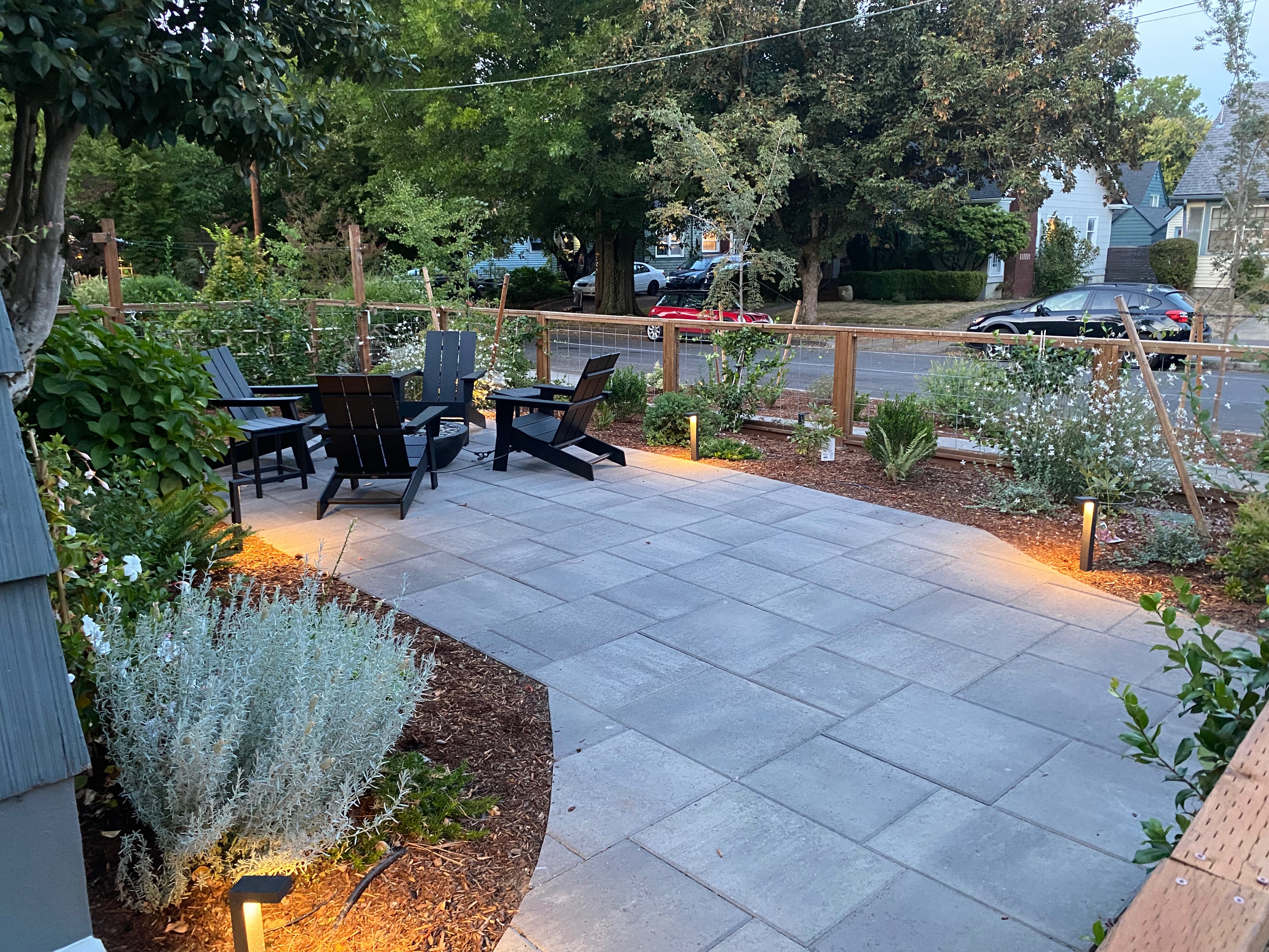 Completed OCL Landscaping paver patio with seating and landscape lighting
